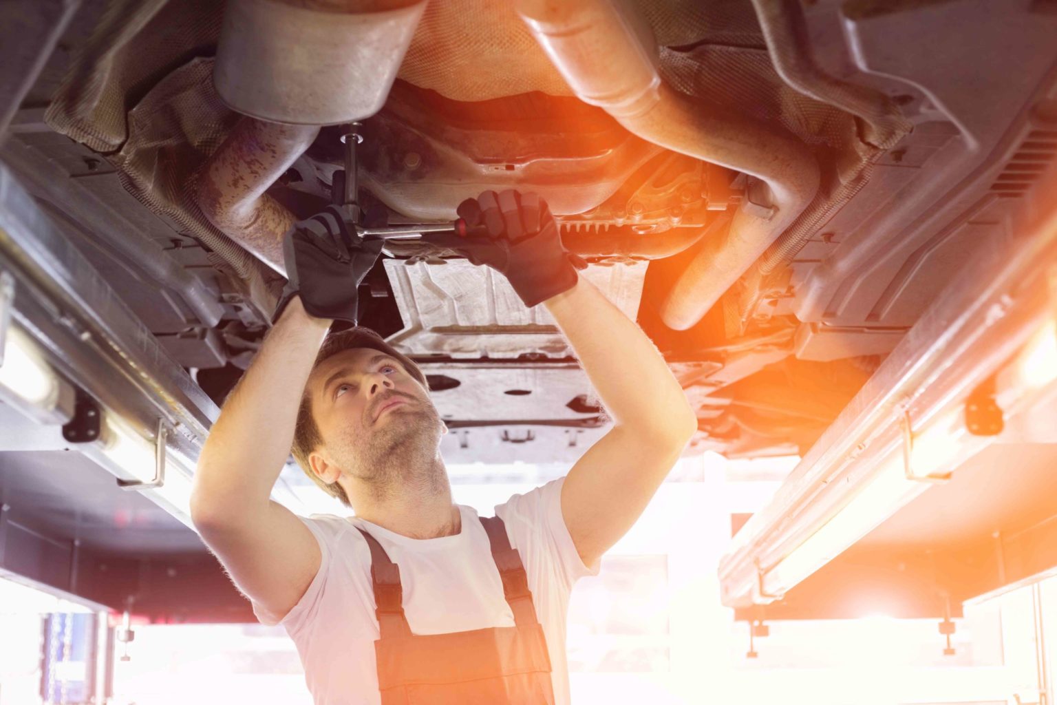 auto repair technician working on a car